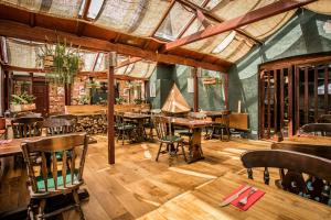 a dining room with wooden tables and chairs at The Barking Buck in Norwich