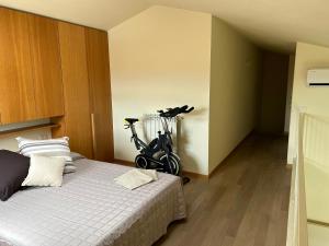 a bedroom with a bike parked next to a bed at Love Lucca Apartment in Lucca +3 photos