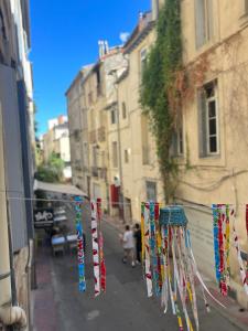 a string of prayer flags hanging on a city street at Le poète roucher in Montpellier