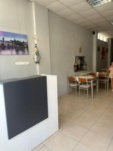 a room with a tv on a wall with a table at EDİRNE EYLÜL PANSİYOn in Edirne