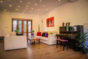 a living room with a couch and a piano at Kings Villa Galle in Galle
