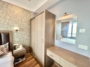 a bedroom with a large cabinet and a mirror at Yepplo's Stunning Mountain View 2-bedroom apartment with Private Kitchen - 24hrs Caretakers & Power Backup in Darjeeling +33 photos