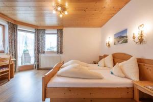 a bedroom with a bed and a wooden ceiling at Appartementhaus Hilde in Neustift im Stubaital