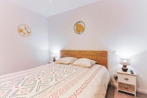 a bedroom with a large bed and two night stands at Mas Lac Blanc - Terrasse - Sauna - Parking in Orbey
