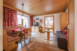 a living room with a table and a dining room at Appartementhaus Hilde in Neustift im Stubaital