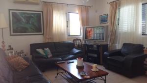 a living room with a couch and a coffee table at Villa Maya in Paralimni
