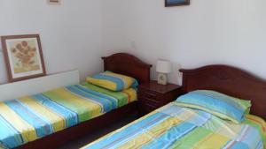 a bedroom with two twin beds and a night stand at Villa Maya in Paralimni +12 photos