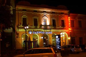 a car parked in front of a building at night at Hotel Dana 2 in Satu Mare