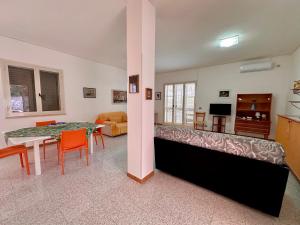 a living room with a table and a dining room at L'isola di Gianni by Ortigia Apartments in Plemmirio