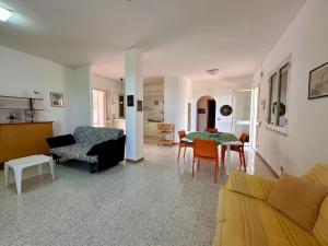 a living room with a couch and a table at L'isola di Gianni by Ortigia Apartments in Plemmirio