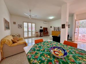a room with a bed and a living room at L'isola di Gianni by Ortigia Apartments in Plemmirio