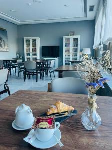 a table with a plate of food and a cup of coffee at Hotel Don Carmelo in Avila