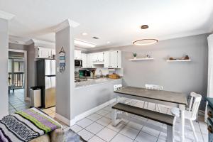 a kitchen and dining room with a table at 2-Bedroom Condo on Gulf Shores Beach w/Pool in Gulf Shores
