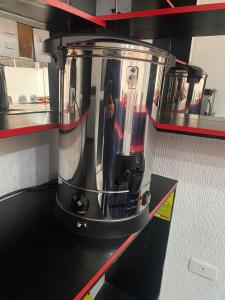 a blender sitting on top of a kitchen counter at Hotel Orozco in Antofagasta +16 photos
