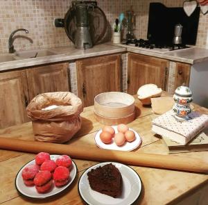 a kitchen counter with plates of cake and strawberries at B&b Romani in Bologna