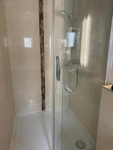 a shower stall with a glass door in a bathroom at Hotel zu den Burgen in Kamp-Bornhofen +53 photos