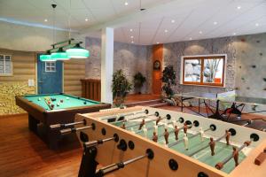 a billiard room with a large pool table at Chalets am Rößle in Todtmoos