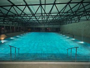 a large indoor swimming pool with blue water at Premium mobile home SUN & JOY - Oaza Mira Camping in Drage