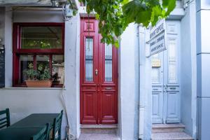 a red door on the side of a building at City Apartment Home in Chios