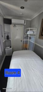 a bedroom with a bed with a room four at JUST ROOMs in Plymouth +16 photos