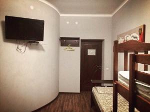 a room with a flat screen tv on a wall at Hostel Serge in Lviv