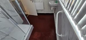 a bathroom with a glass shower and a sink at JUST ROOMs in Plymouth