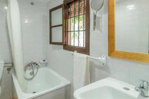 a white bathroom with a sink and a mirror at Alojamiento LA GUITARRA ANDALUZA in Loja +26 photos