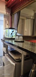 a kitchen with a counter with a fish tank on it at JUST ROOMs in Plymouth
