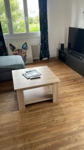 a living room with a coffee table and a tv at Ker Breizh in Saint-Brieuc