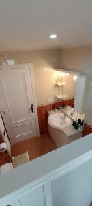 a bathroom with a white sink and a mirror at Apartamento Isabel in Torrevieja +76 photos