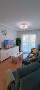 a living room with a couch and a tv at Apartamento Isabel in Torrevieja