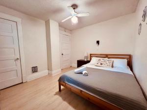 a bedroom with a bed and a ceiling fan at Zen style 3 bedrooms walking to the Falls USA in Niagara Falls +21 photos