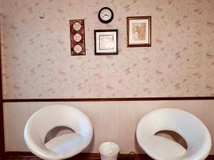 two white urinals sitting next to each other on a wall at Zen style 3 bedrooms walking to the Falls USA in Niagara Falls