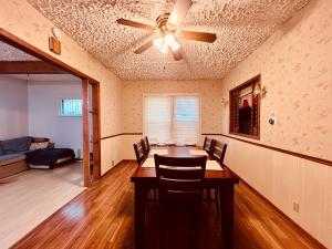 a dining room with a table and a ceiling fan at Zen style 3 bedrooms walking to the Falls USA in Niagara Falls