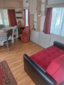 a living room with a red couch and a table at Olga in Łeba