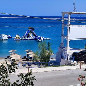 a roller coaster in the water next to a beach at Voukamvilia apartment in Paralia Kimis