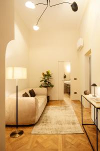 ein Wohnzimmer mit Sofa und Tisch in der Unterkunft Domus Dionisio Apt by Addler House Ospitality in Syrakus