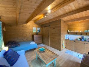 a log cabin with a bed and a table at Casita Louisa in Chiclana de la Frontera +11 photos