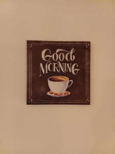 a chalkboard with a cup of coffee on a wall at Hostel Flash in Ulcinj