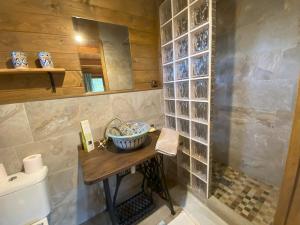 a bathroom with a sink and a counter with a mirror at Casita Louisa in Chiclana de la Frontera