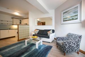 a living room with a couch and a table at Parnell Boulevard Apartments in Dublin