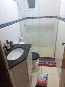 a small bathroom with a sink and a toilet at Quarto de Casal Bem Localizado Em apto Compartilhado AP 204 in Uberaba +5 photos