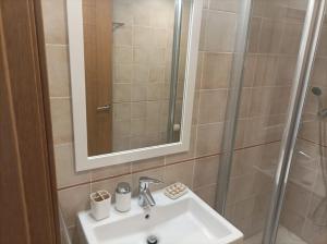 a bathroom sink with a shower and a mirror at Apartamento Califato 5 in Mojácar +34 photos