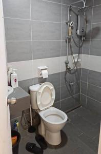 a bathroom with a toilet and a shower at TT3 soho kuching in Kuching