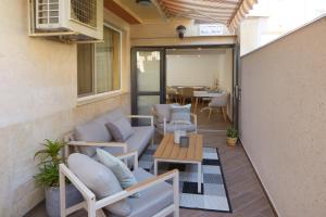 a patio with couches and a table and a dining room at Villa Nasko Chaushev in Nesebar
