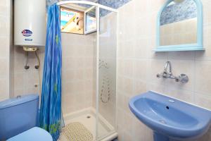 a bathroom with a blue toilet and a sink at Villa Nasko Chaushev in Nesebar +24 photos