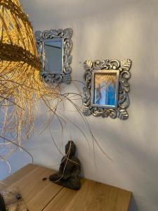 a room with two mirrors on a wall with a statue at La Casita Turquesa in Almuñécar +13 photos