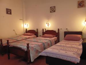 two beds in a room with lights on the wall at Hostel Flash in Ulcinj