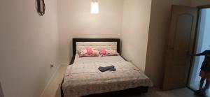 a small bedroom with a bed with a hat on it at Sara&Sami in Mostar