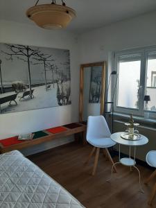 a bedroom with a bed and a table and chairs at Mosel statt Mallorca in Mesenich